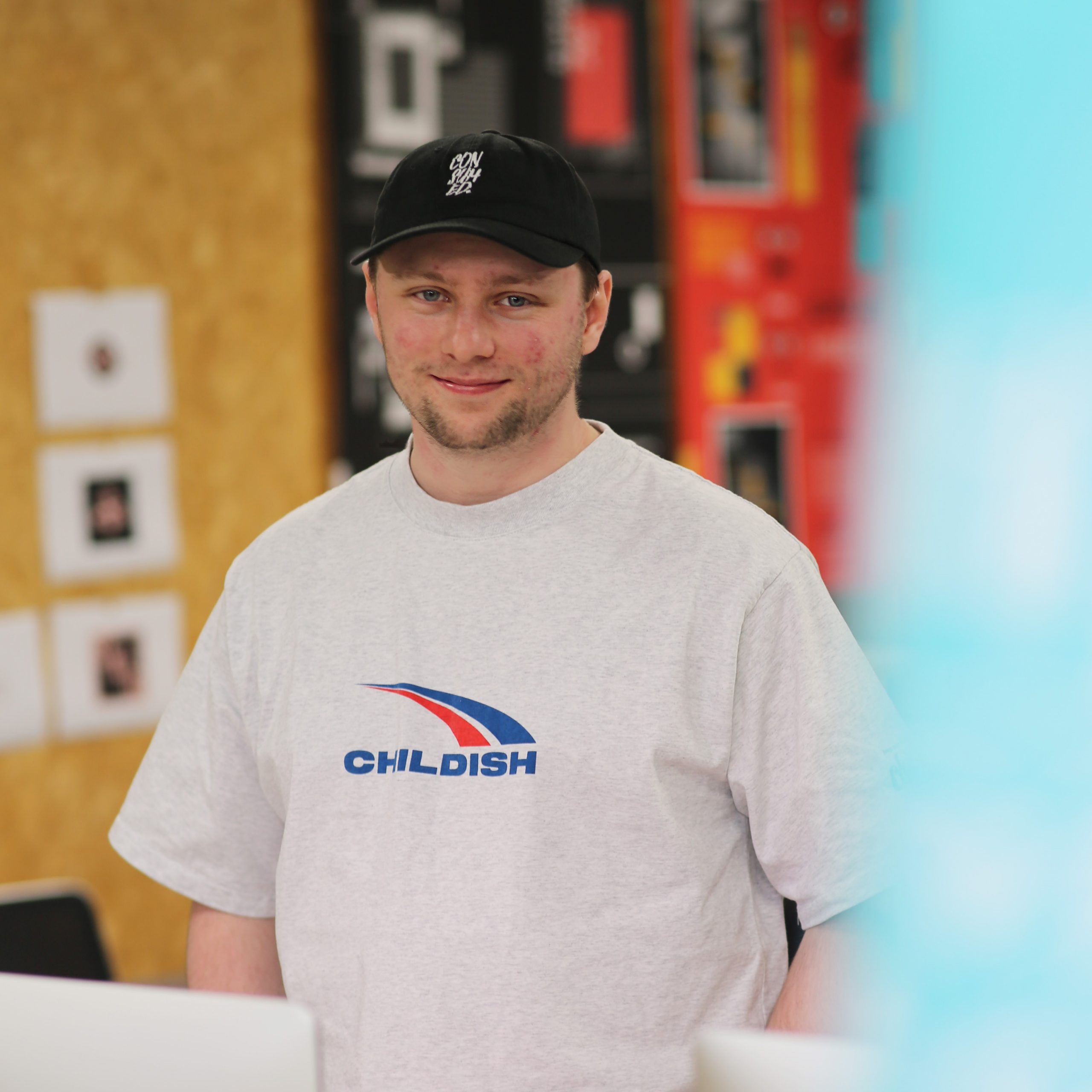 Male student dan stood in design studio looking and smiling at camera