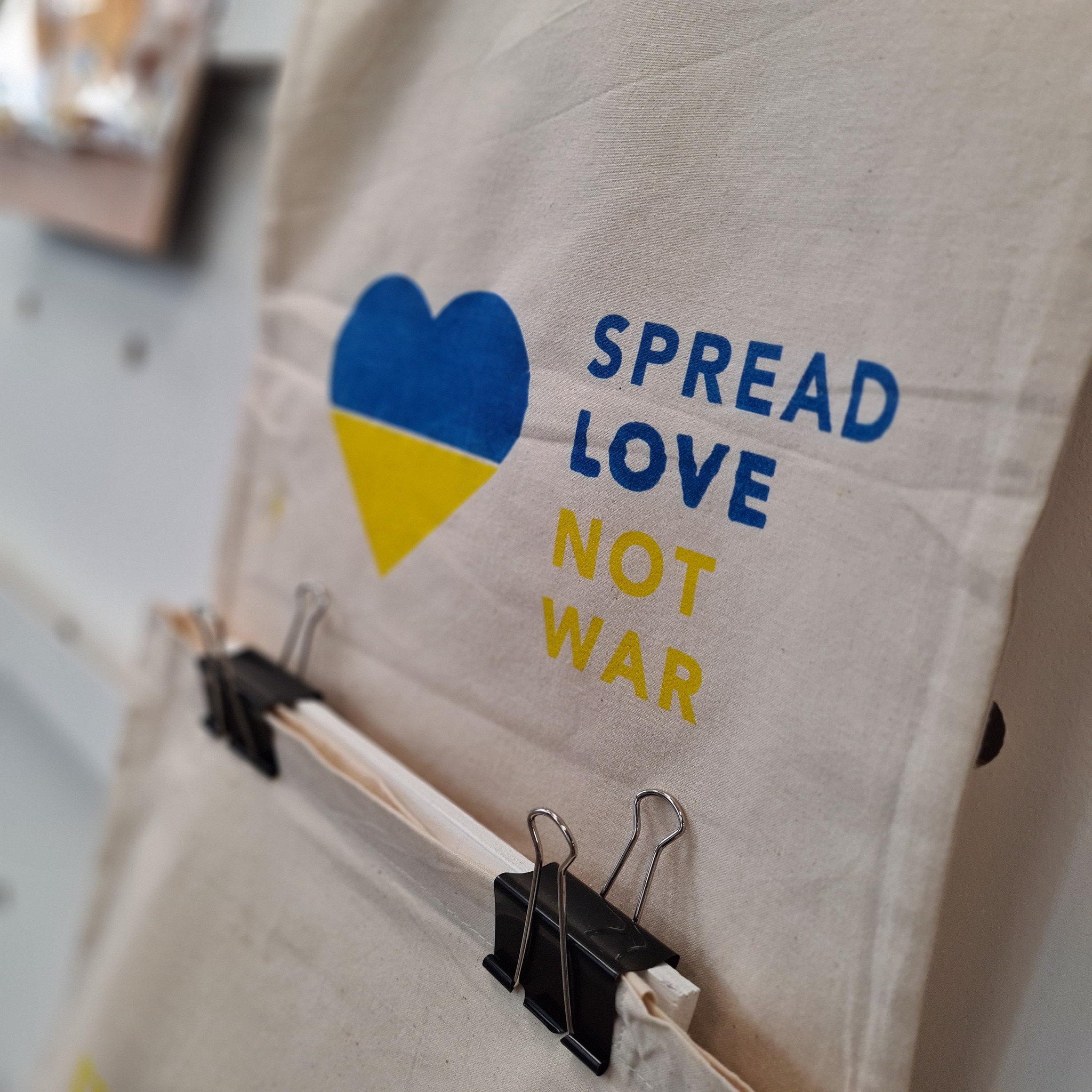 Fabric saying 'Spread love not war'