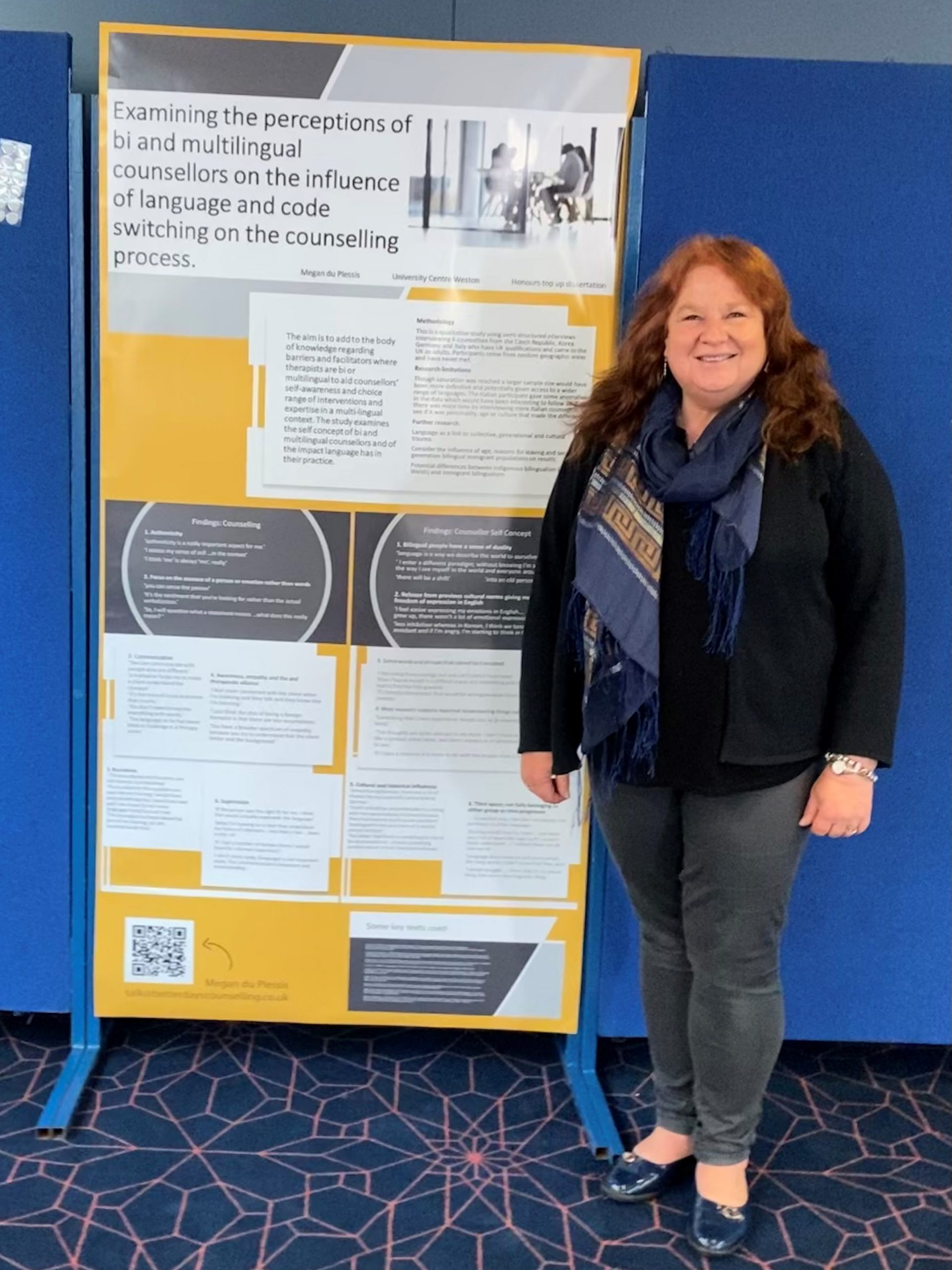 Female student stood in front of academic poster