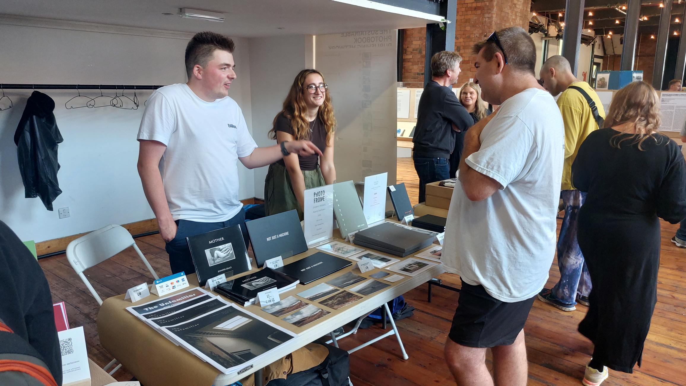 Zoe and classmate Joe selling photobooks