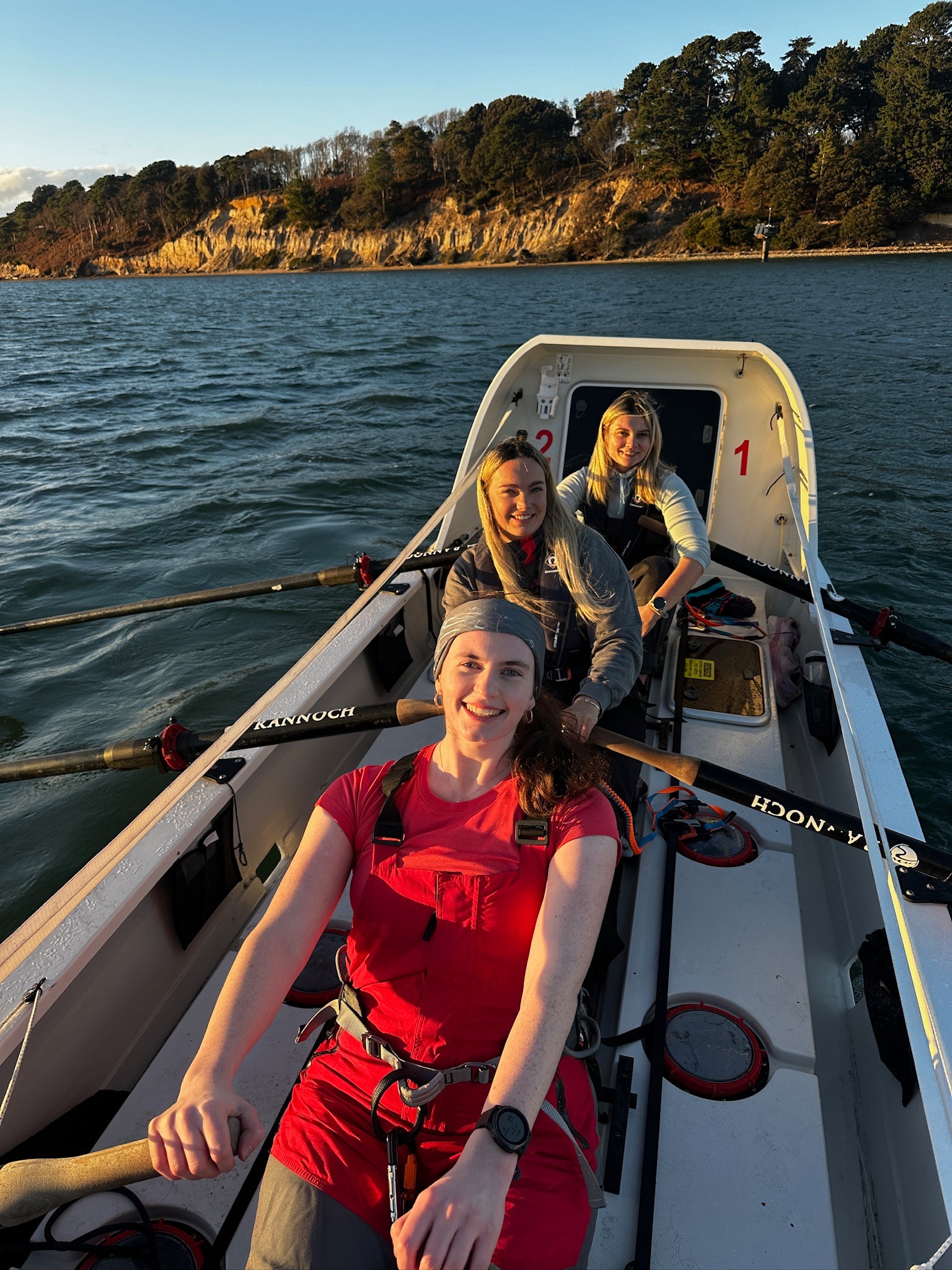 Front-to-back_-Meg-Neely-Jenna-Vincent-and-Olivia-Stocks-on-a-training-row-in-Poole-Harbour.