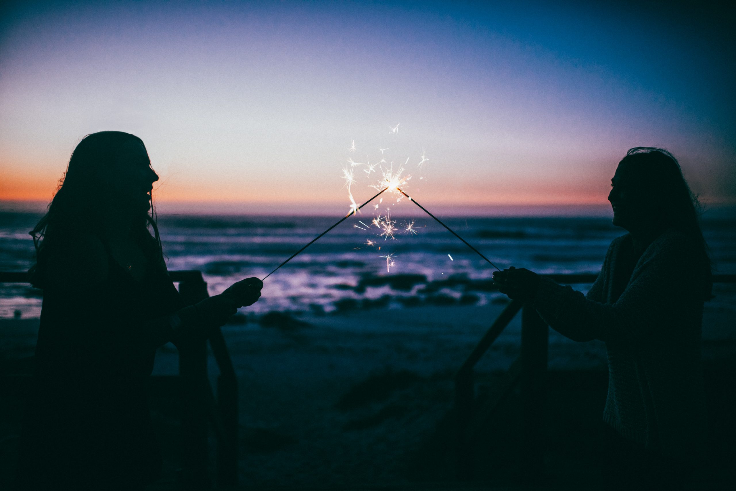 degree students holding sparklers on weston beach outside university centre weston