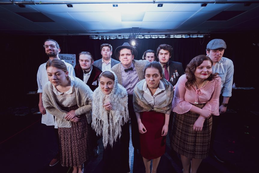 Group of male and female Performing Arts students performing show dressed in costumes