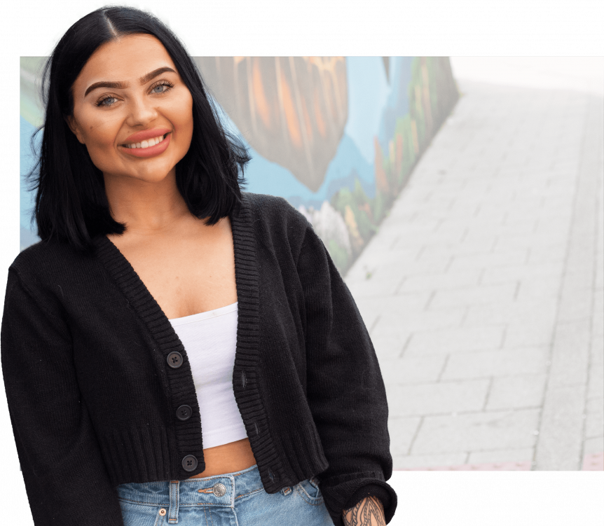 Female Media student smiling at camera with Photoshopped background