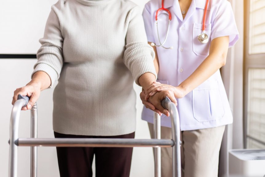 health care worker aiding elderly patient