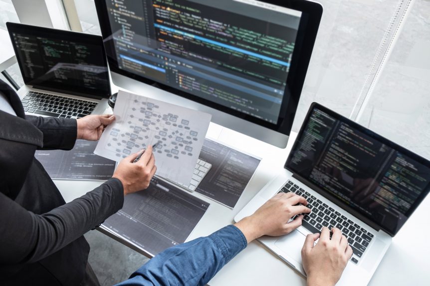 professional team of programmer working on project in software development computer in it company