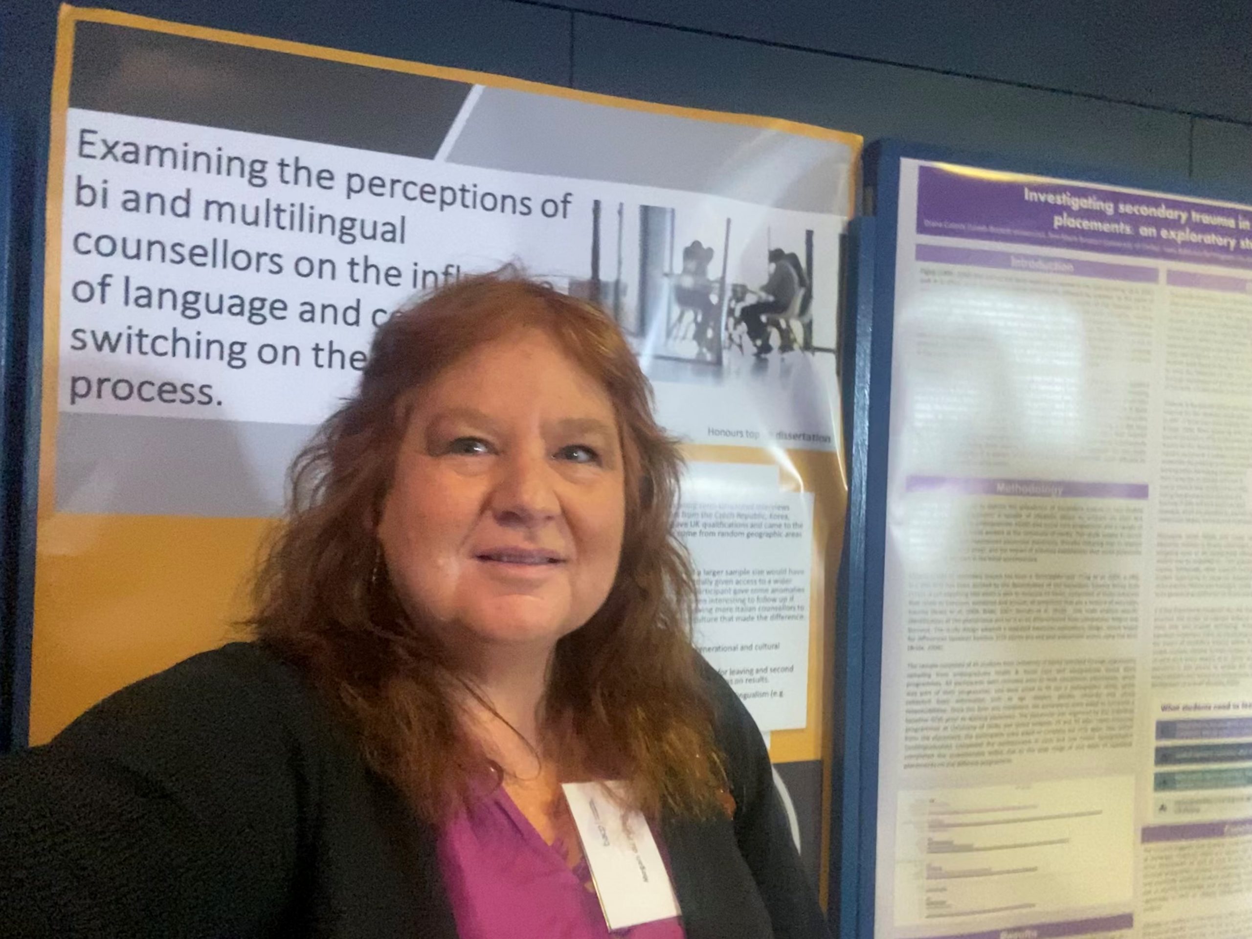 Female student stood in front of academic poster