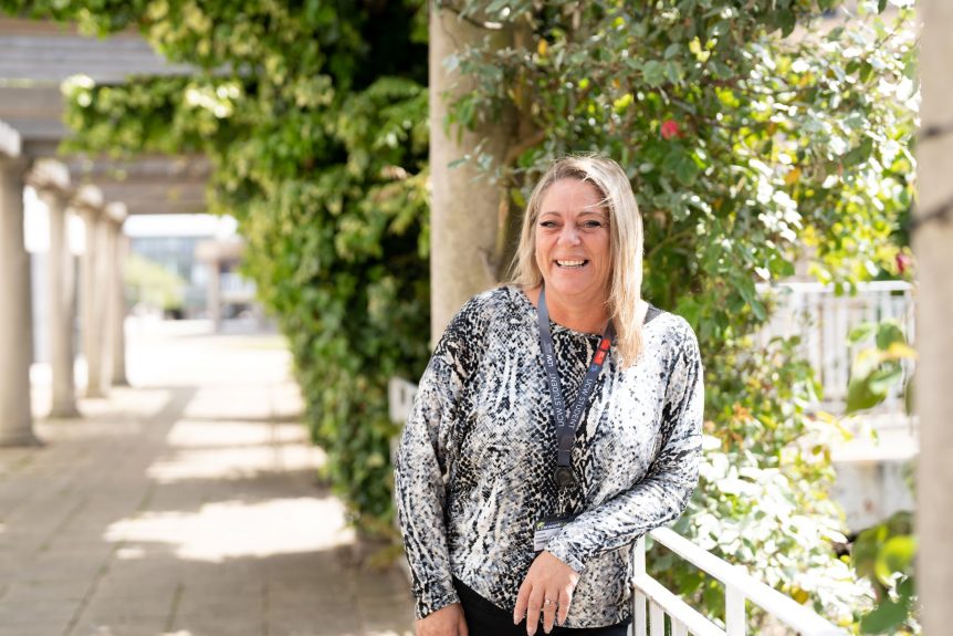 Female Inclusive Practice student standing in front of trees and smiling