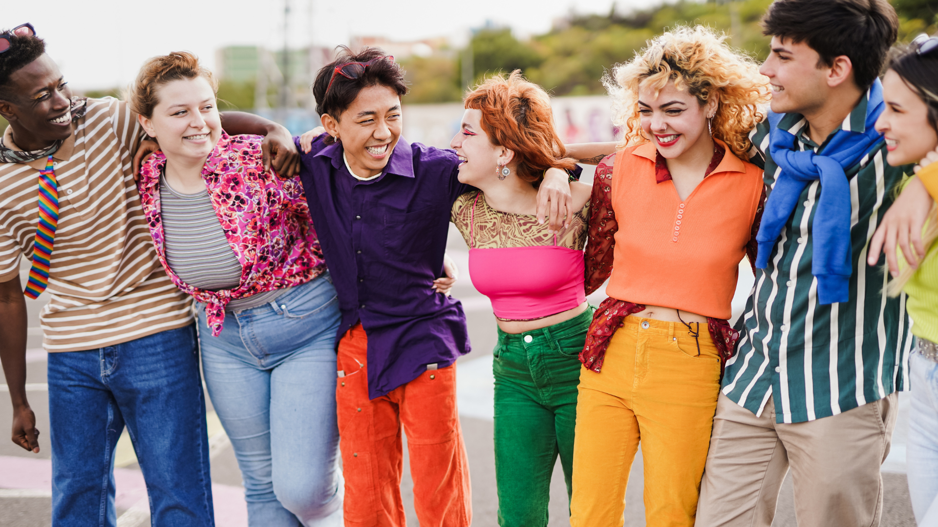 diverse group of teenagers linking arms