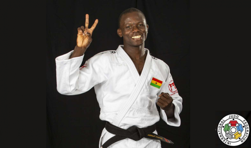 Dr Nartey in Judo kit holding up peace sign
