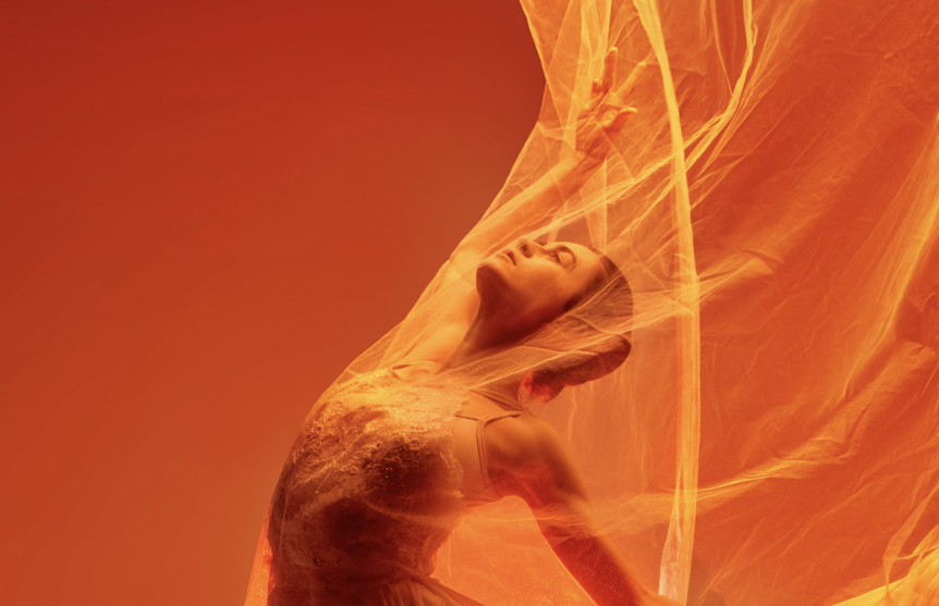 ballerina dancer dancing with orange cloth in studio