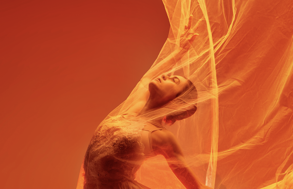 ballerina dancer dancing with orange cloth in studio