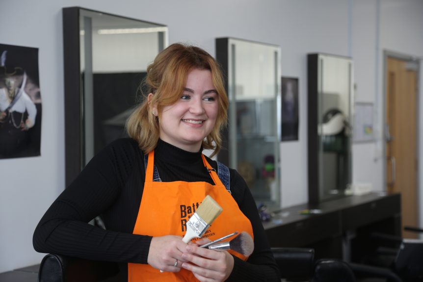 Poppy in Make-up studio holding make-up brushes