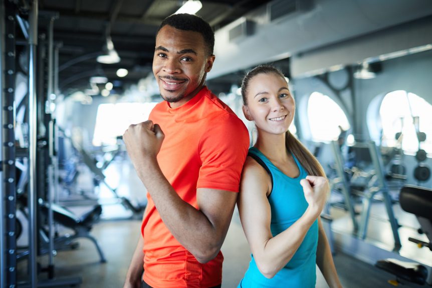 Female and male sport coach pose for camera