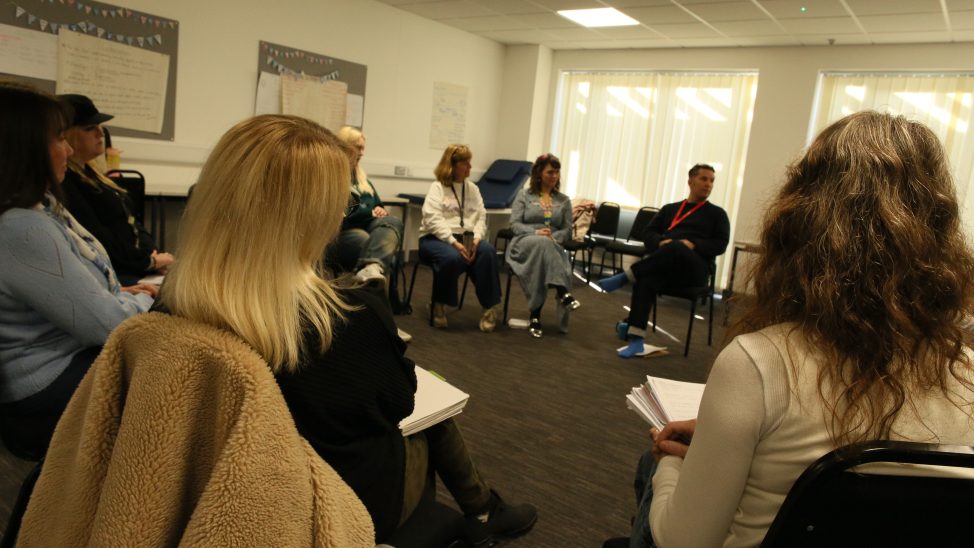 Counselling students sat in a circle with a guest lecturer