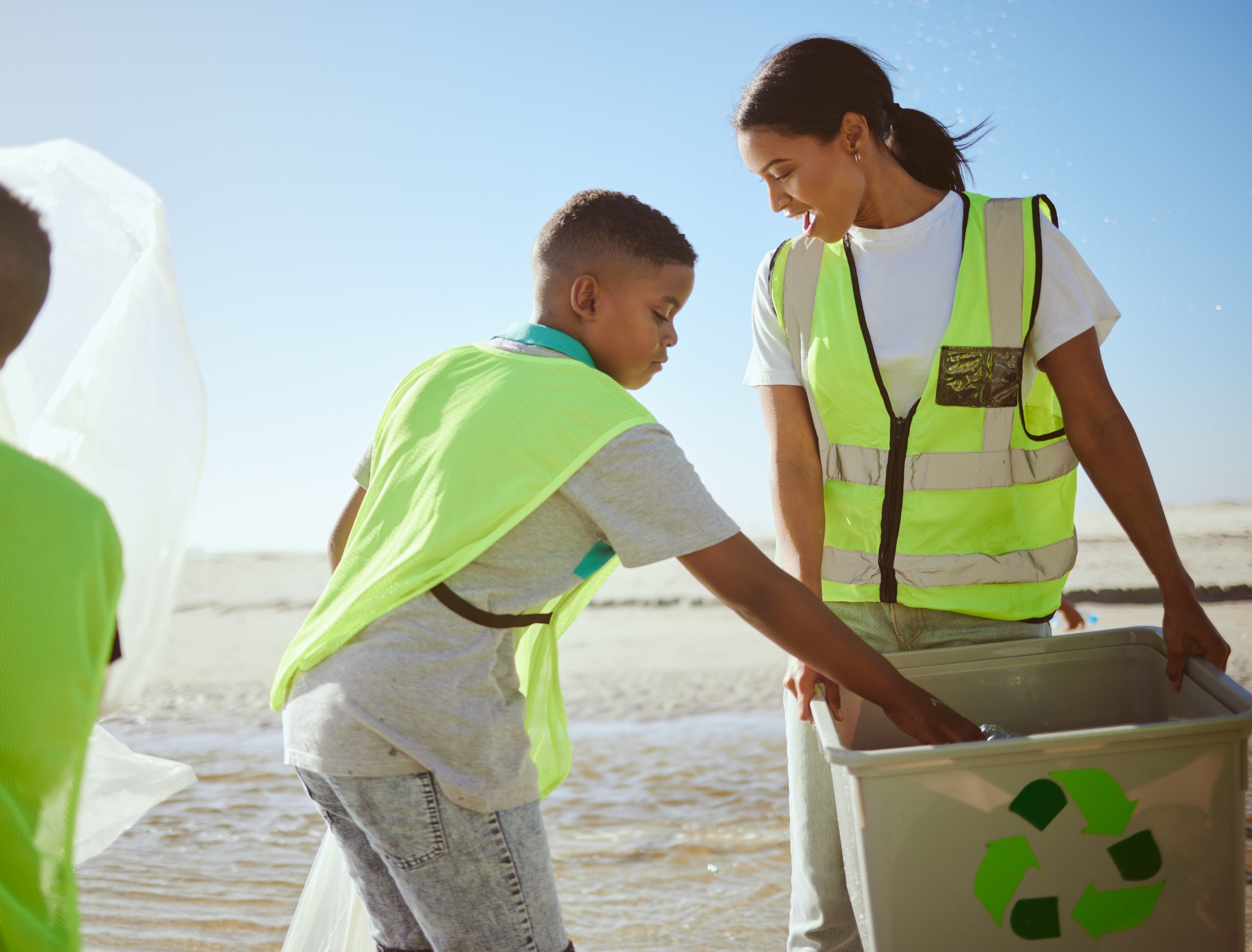 University student helping children recycled and beach clean during community beach clean event run by Business and Biolab Sustainability Society
