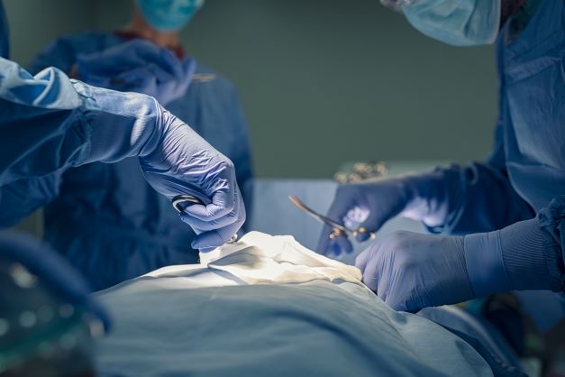 Close up of surgeons performing surgery on patient