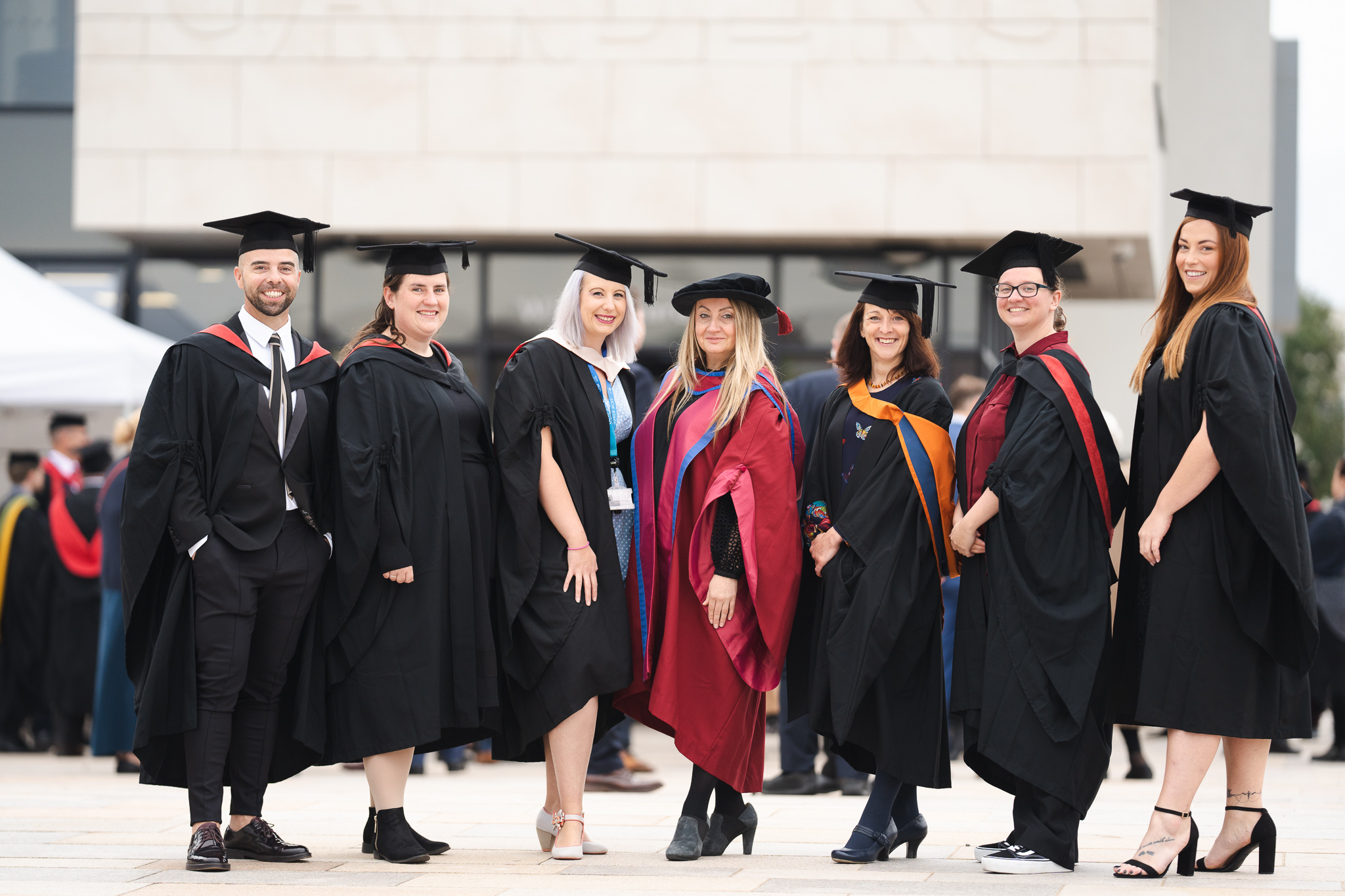 students wearing graduation gowns outside at university centre weston