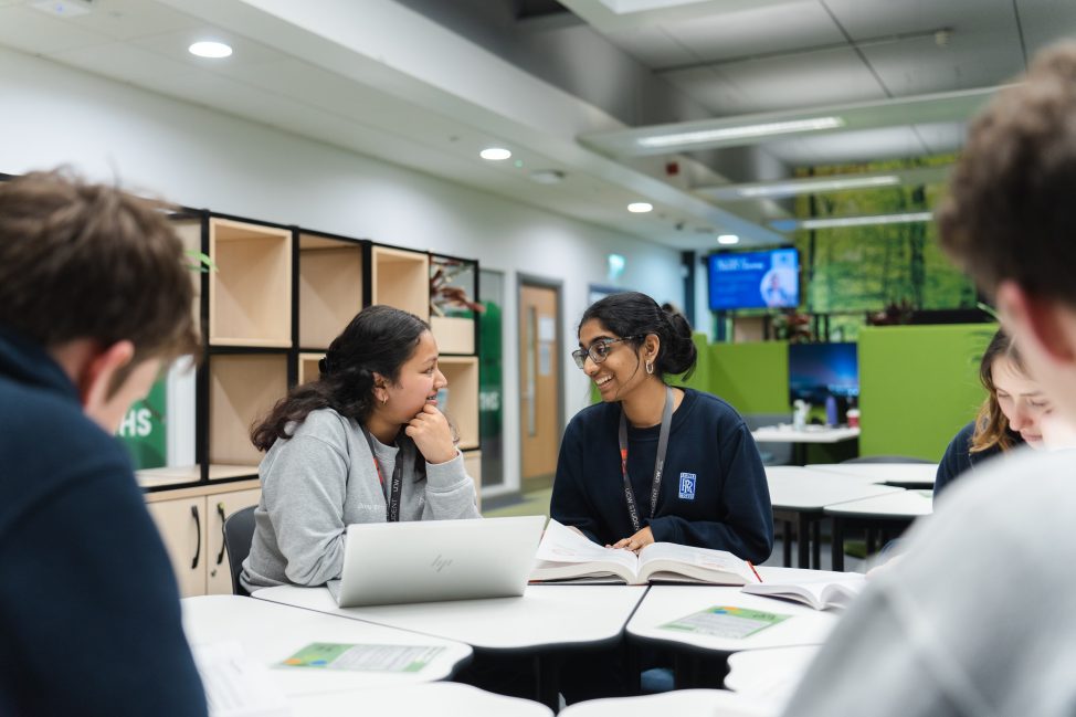 Learners working together on a project in the library