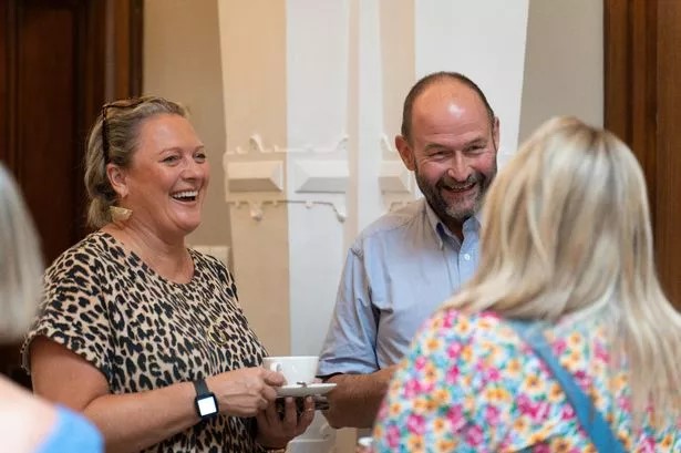 Group of 3 adults at an event laughing