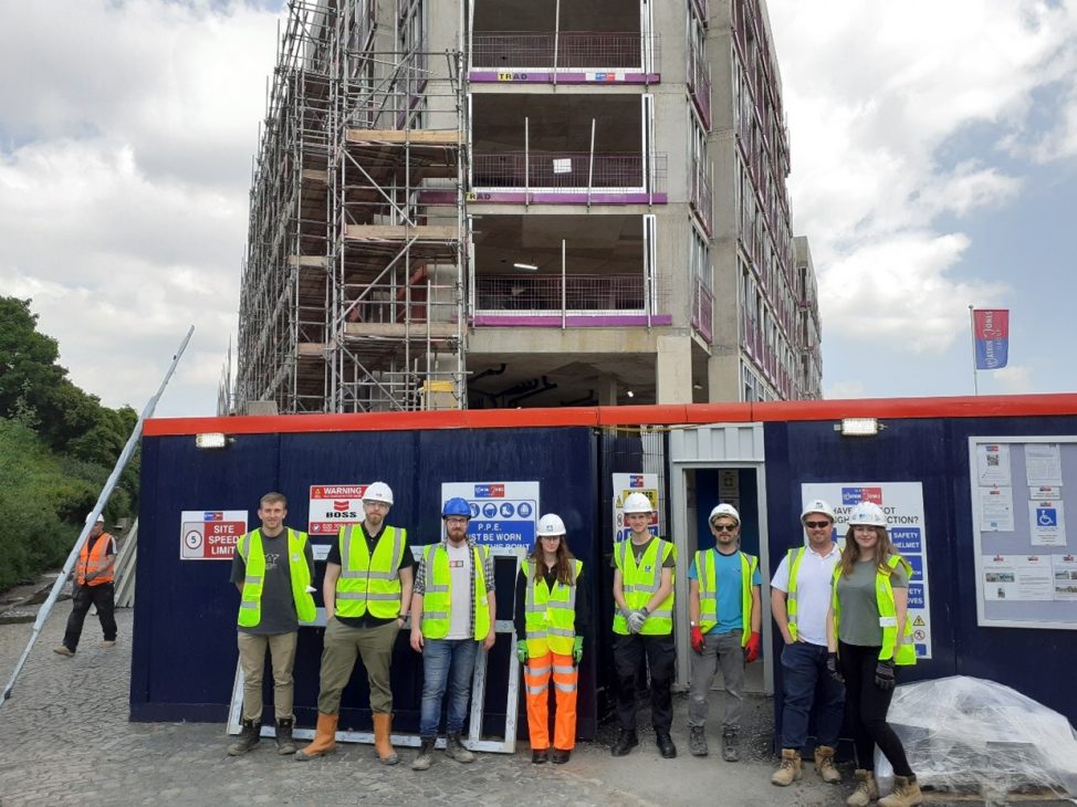 Group of learners standing infront of building on their trip.