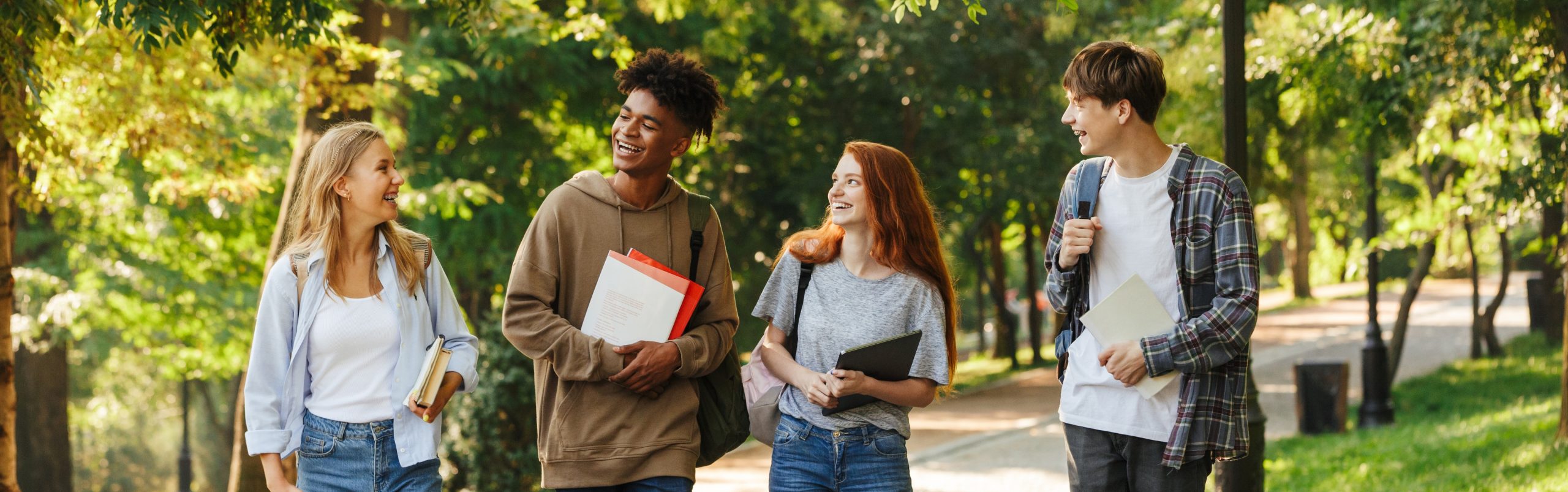Group of happy students walking at the campus
