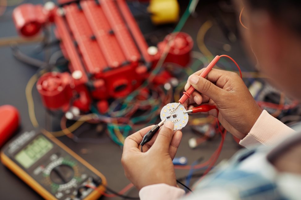 Person hands building robot closeup