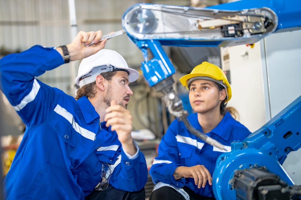 engineer with robot in automotive parts factory