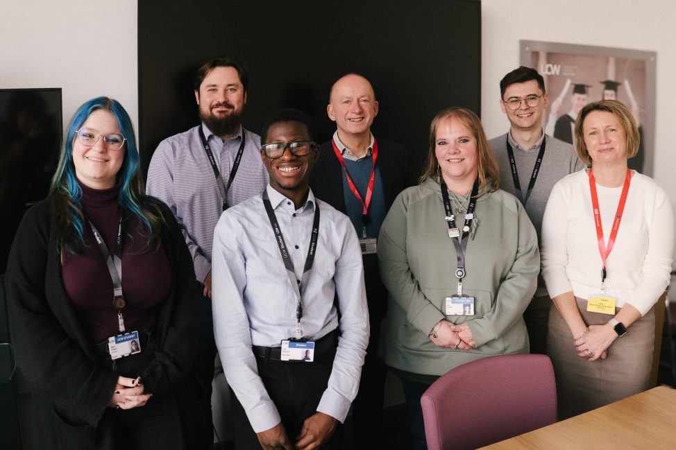 Students standing with representatives from the OfS