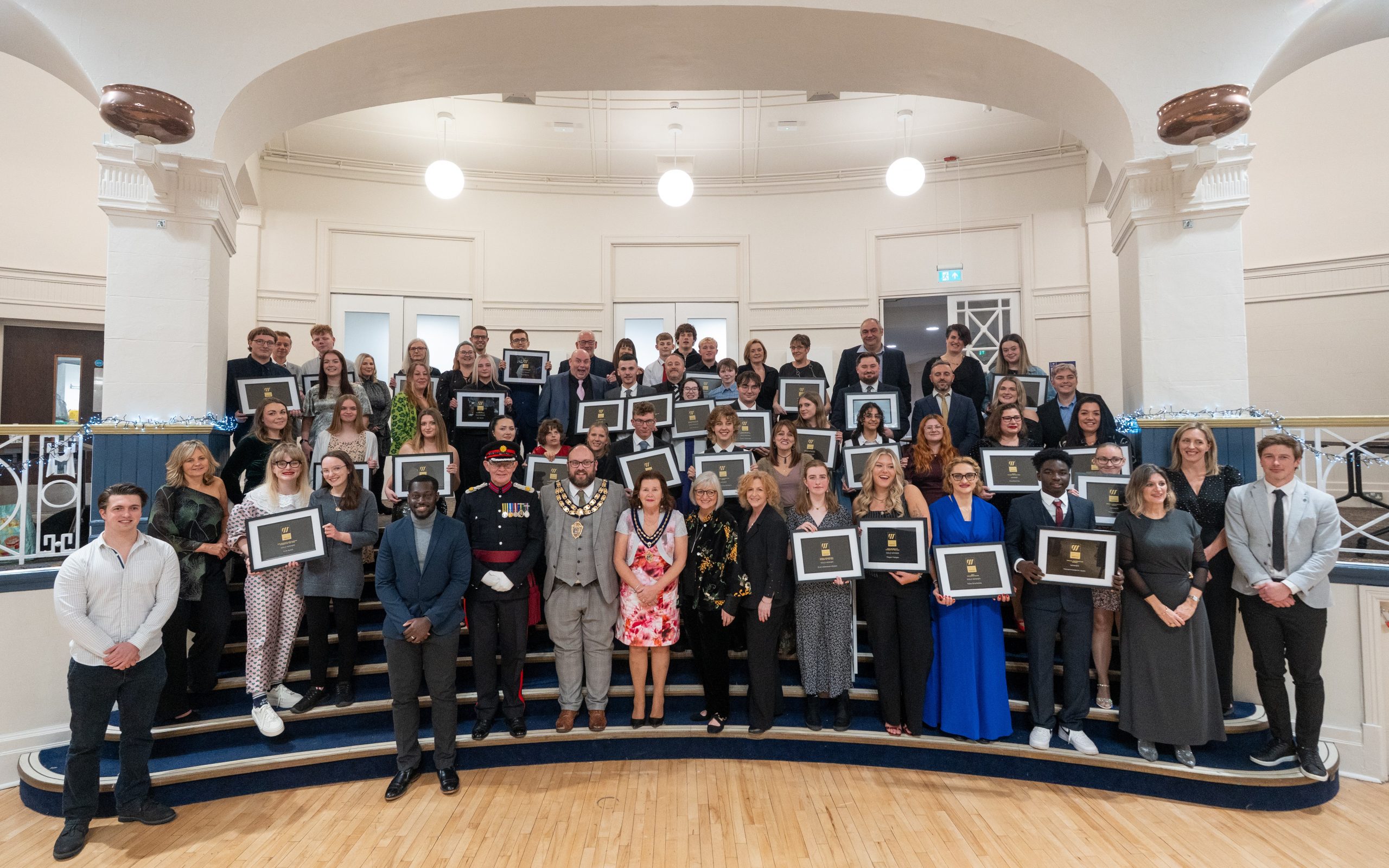 Winners with their awards on stage