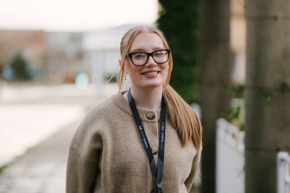 Darcey Robbins smiling at the camera outside UCW