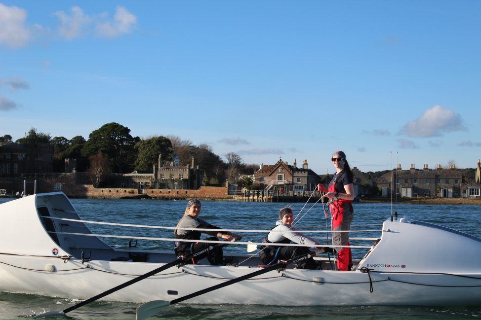 Left-to-right_-Jenna-Vincent-Olivia-Stocks-Meg-Neely-on-a-training-row-in-Poole-Harbour